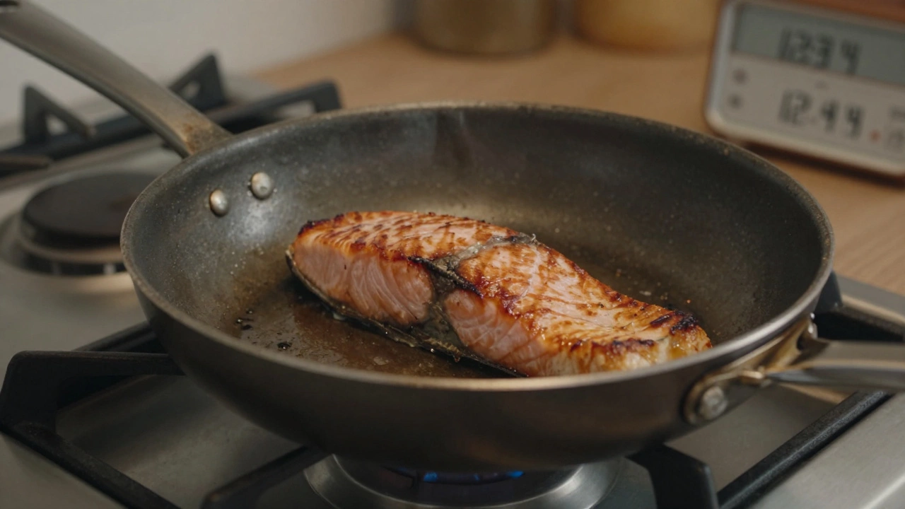 Well-used ScanPan with seared salmon on a gas stove, showing wear and heat shimmer.